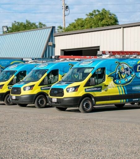 Cosmic Comfort electrical and hvac service vans parked in front of headquarters.