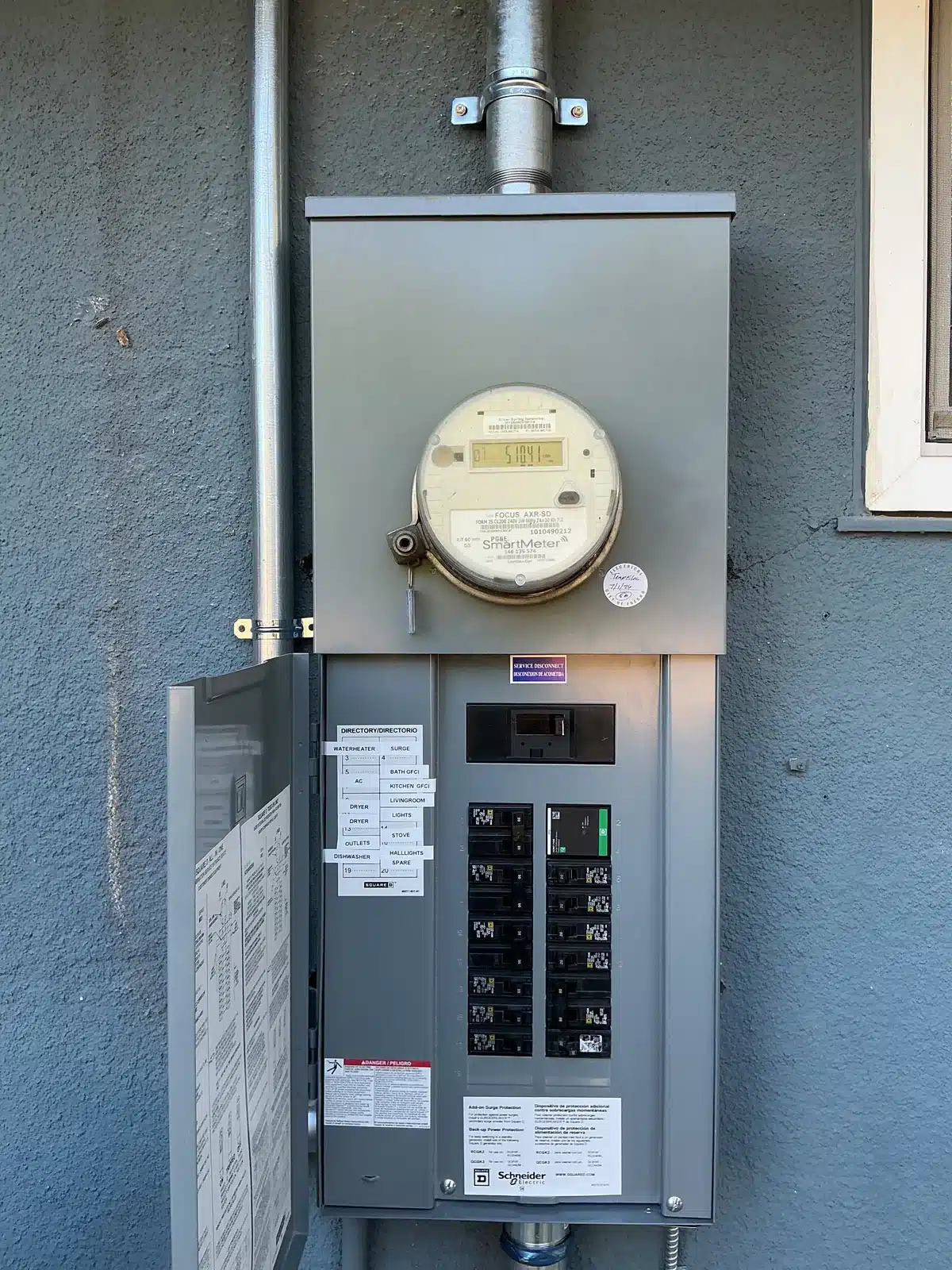 Newly installed meter and main electrical panel on a blue stucco home in Fresno, CA